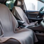 A clean car interior showing how to cover car seat with blanket using a soft, neatly draped fabric for temporary protection and comfort.