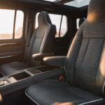 Modern SUV interior with black West Llama linen seat covers featuring triangular pattern for breathable comfort and universal protection.