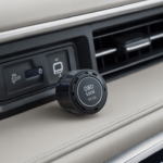 Close-up view of the best OBD port lock anti theft device for cars placed near a modern vehicle dashboard air vent for enhanced security
