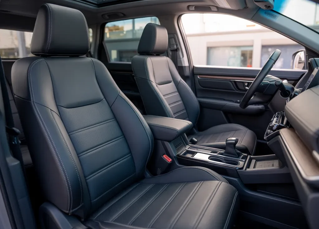 Stylish black leather car interior featuring EKR Custom Fit Honda CR-V Seat Covers with precise stitching and a factory-style finish