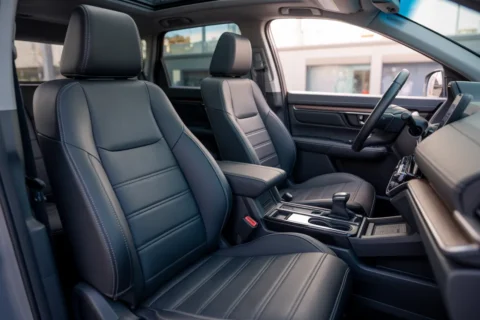 Stylish black leather car interior featuring EKR Custom Fit Honda CR-V Seat Covers with precise stitching and a factory-style finish