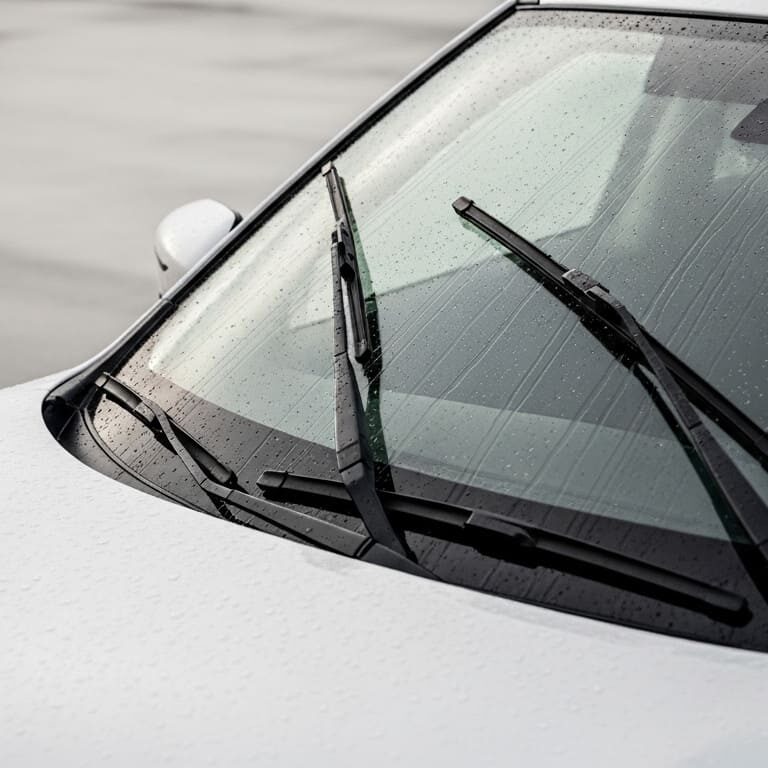Best Wiper Blades for Nissan Rogue: Size, Buying Guide & Top Picks – close-up of windshield wipers clearing rainwater on a Nissan Rogue, showing clean glass and improved visibility during wet conditions