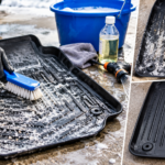 A person scrubbing a salt-covered rubber car mat to demonstrate how to remove road salt from rubber car mats, with a clean mat shown beside it.